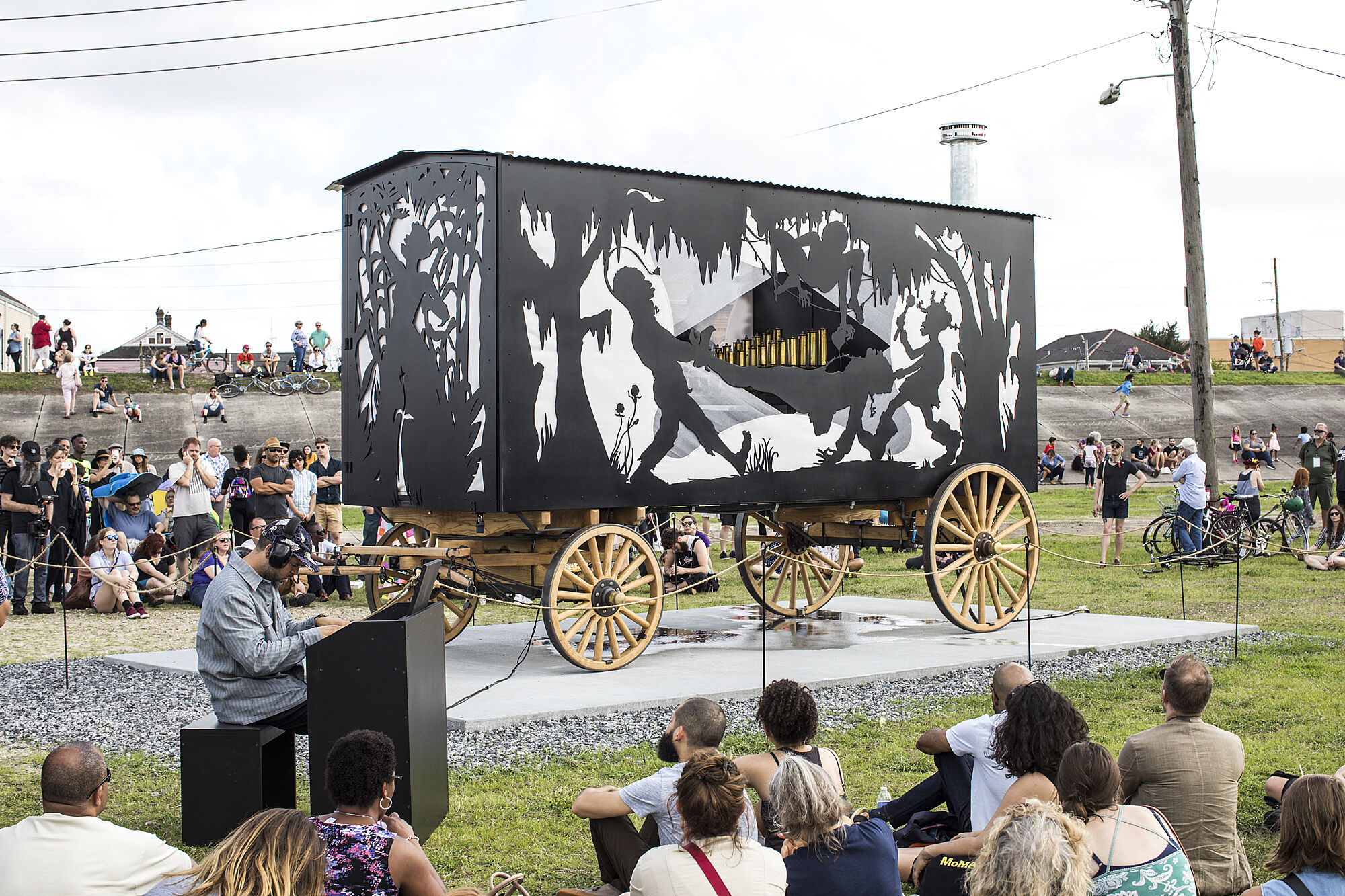 A steam calliope featuring silhouetted figures on the exterior, with Jason Moran playing the calliope in the foreground