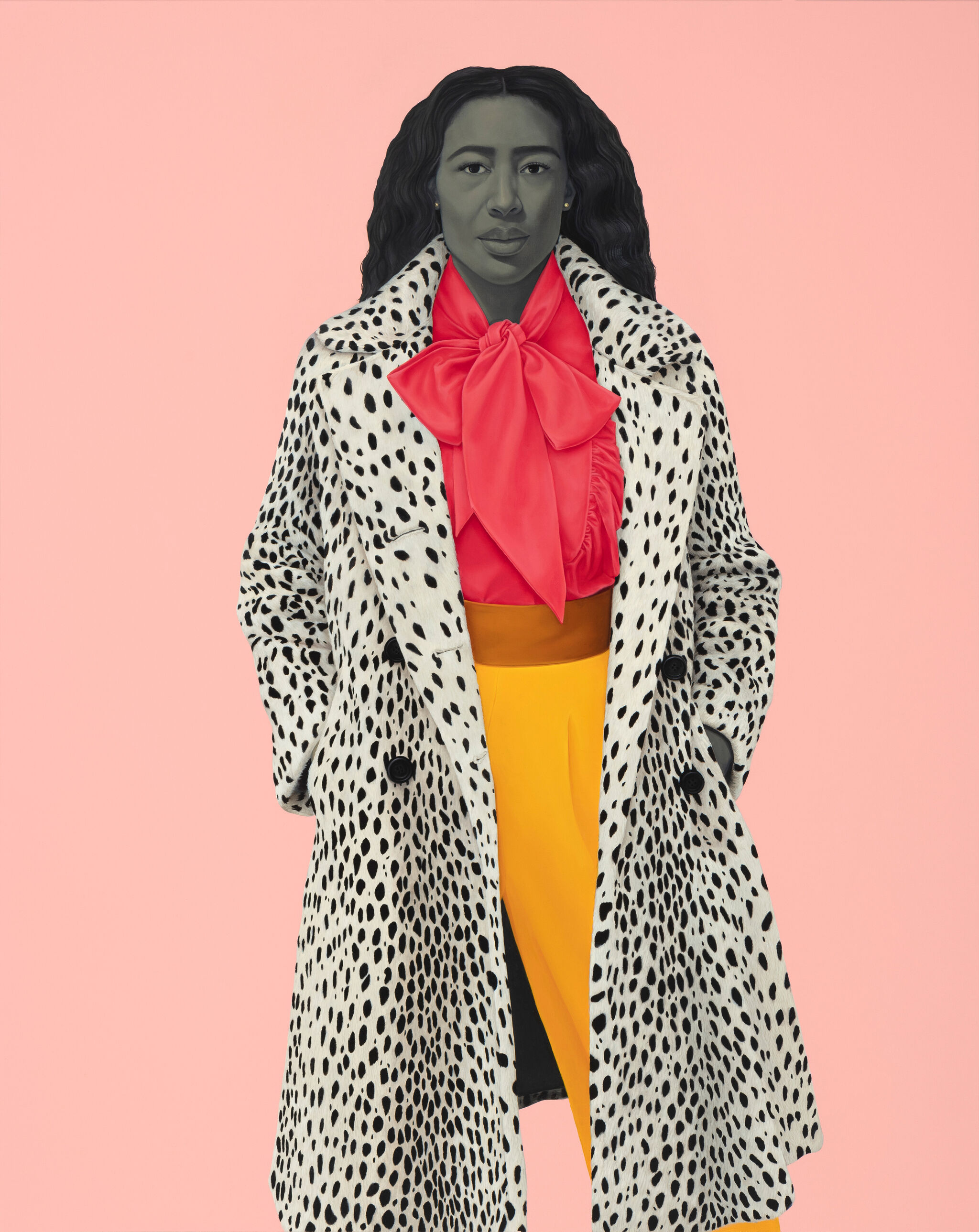 A woman wearing a leopard print coat, pink blouse and yellow pants is standing with her hands in the coat pocket staring back at the viewer against a pink backdrop.