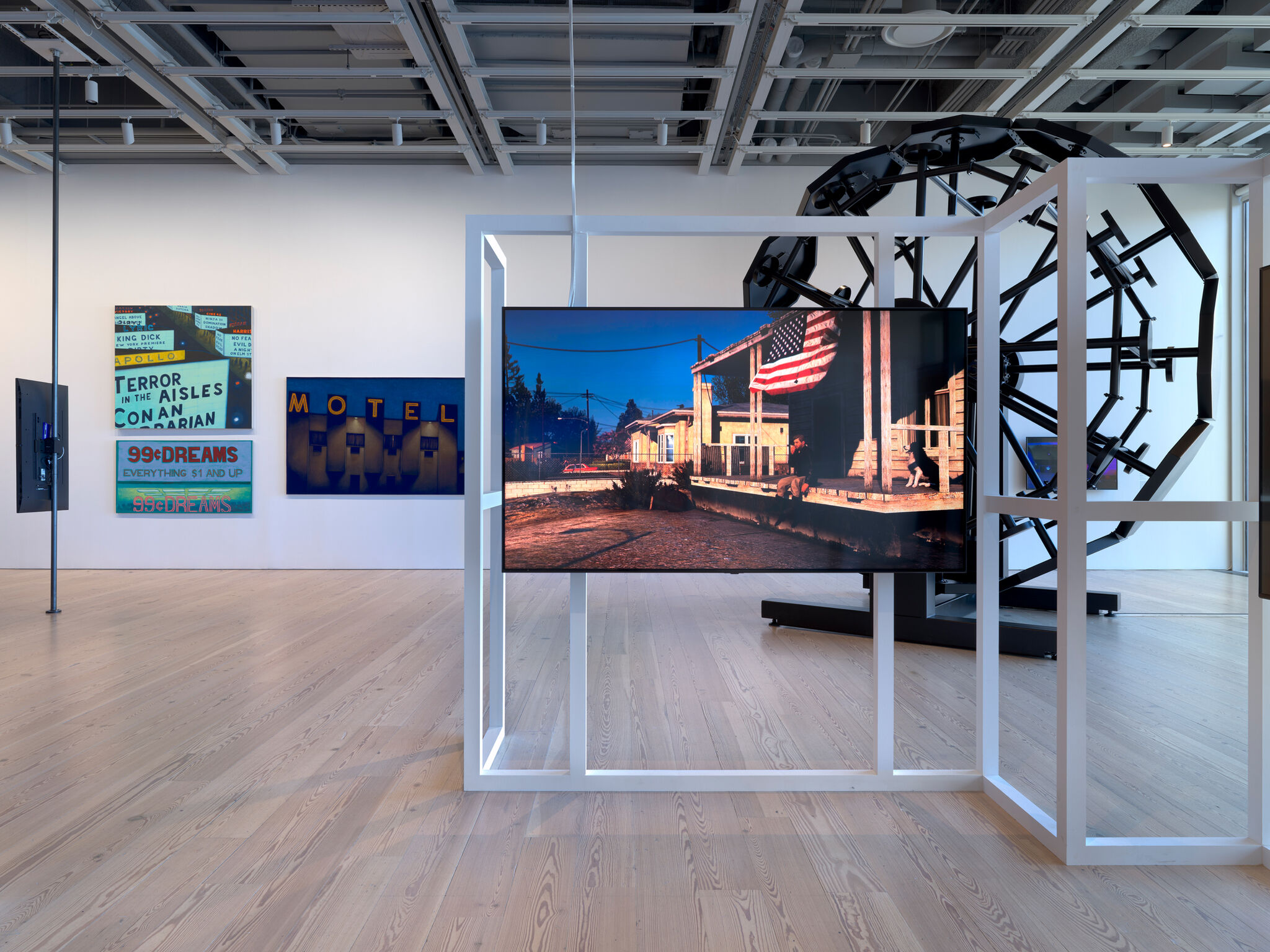 Multiple artworks in a light-filled gallery.