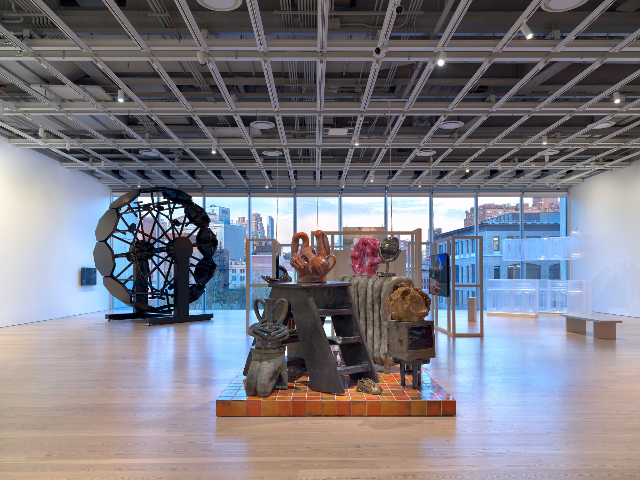 Multiple artworks in a light-filled gallery.